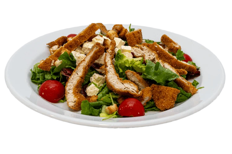 Crispy salad with fried and sliced turkey meat